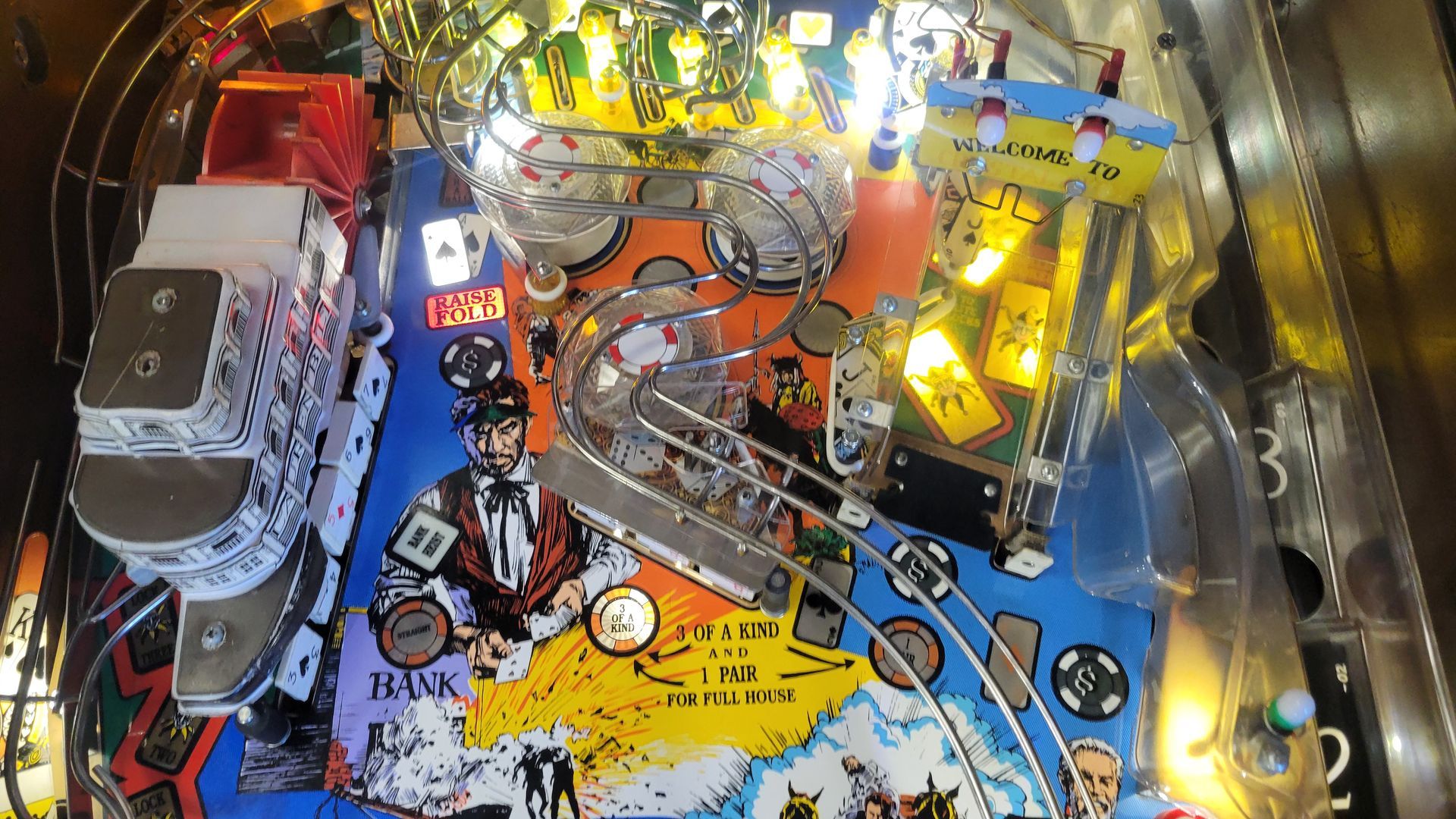 A close up of a pinball machine with lights on it.