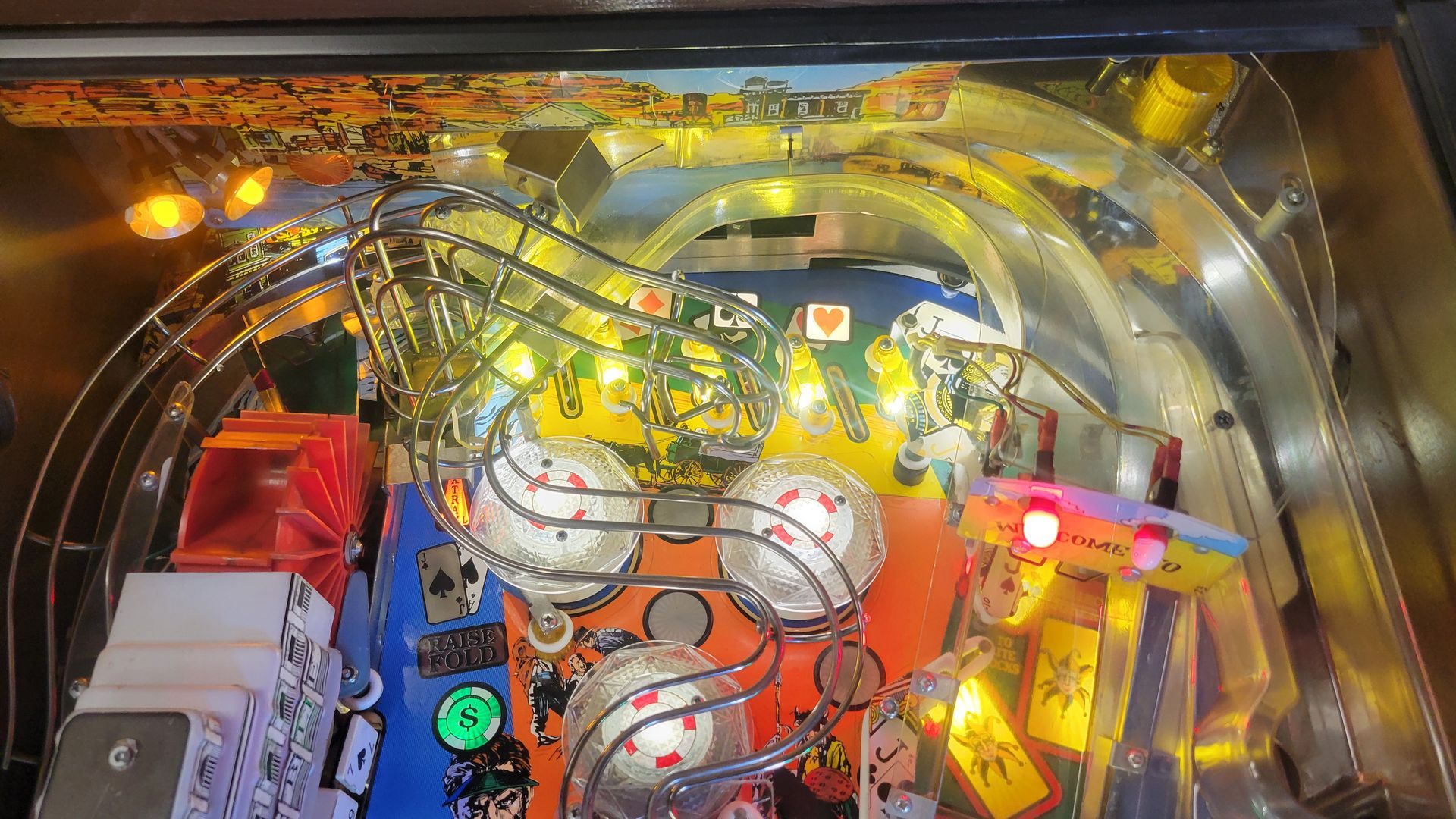 A close up of a pinball machine with lights on it.