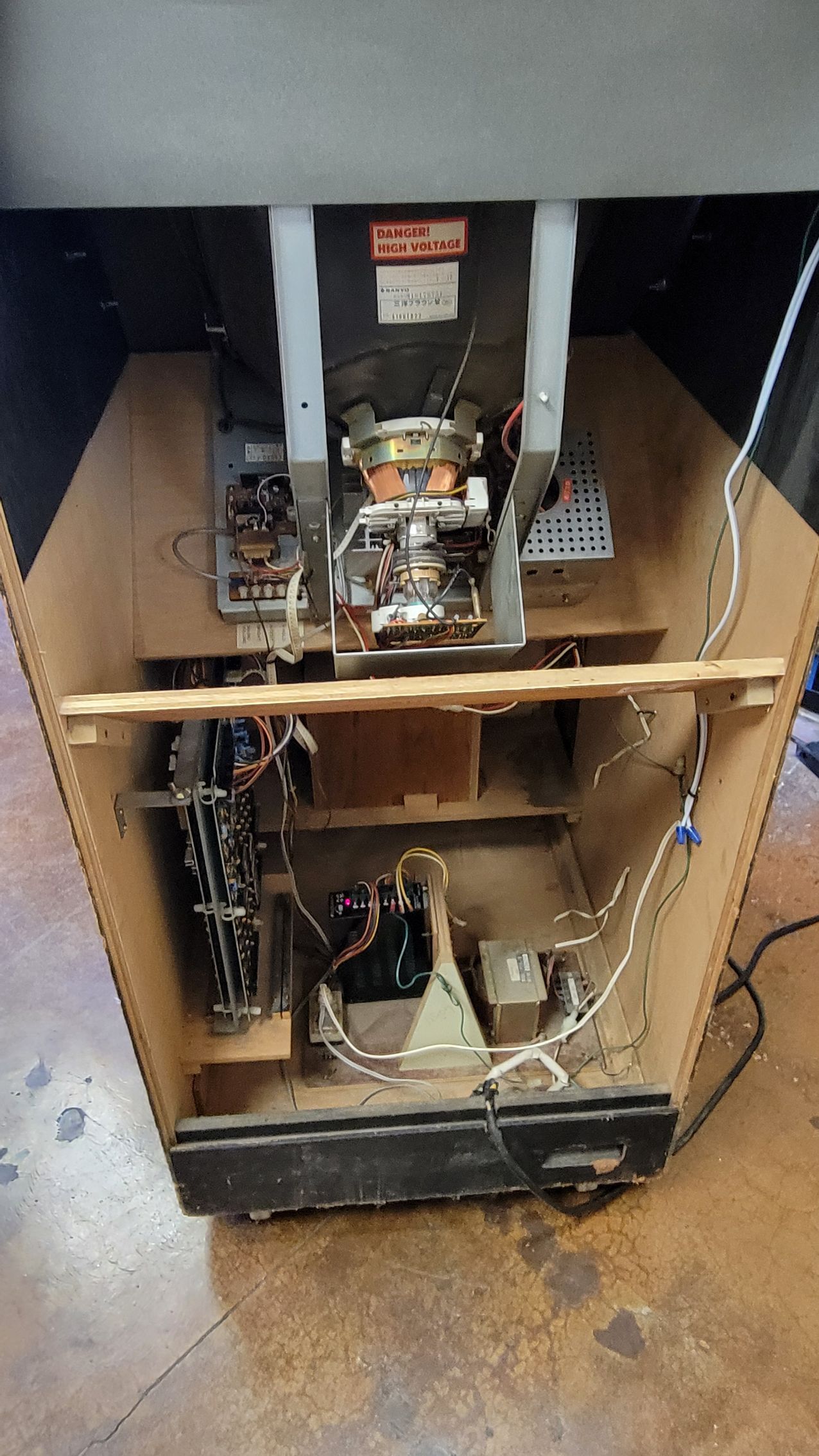 The inside of an old arcade machine is shown.