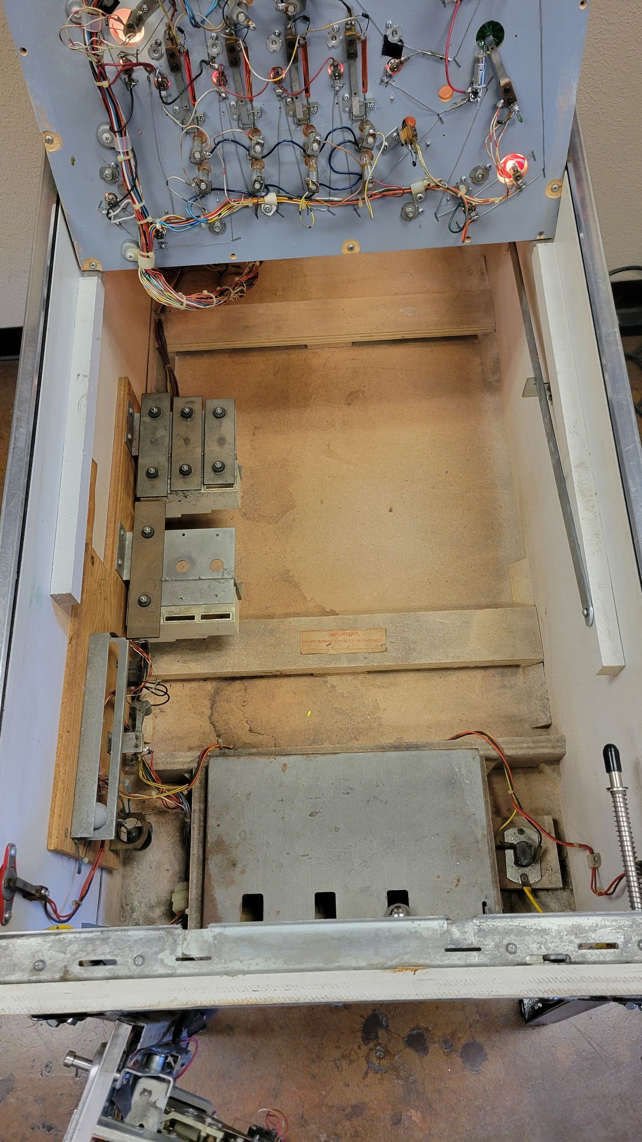 The inside of a machine with a lot of wires coming out of it.