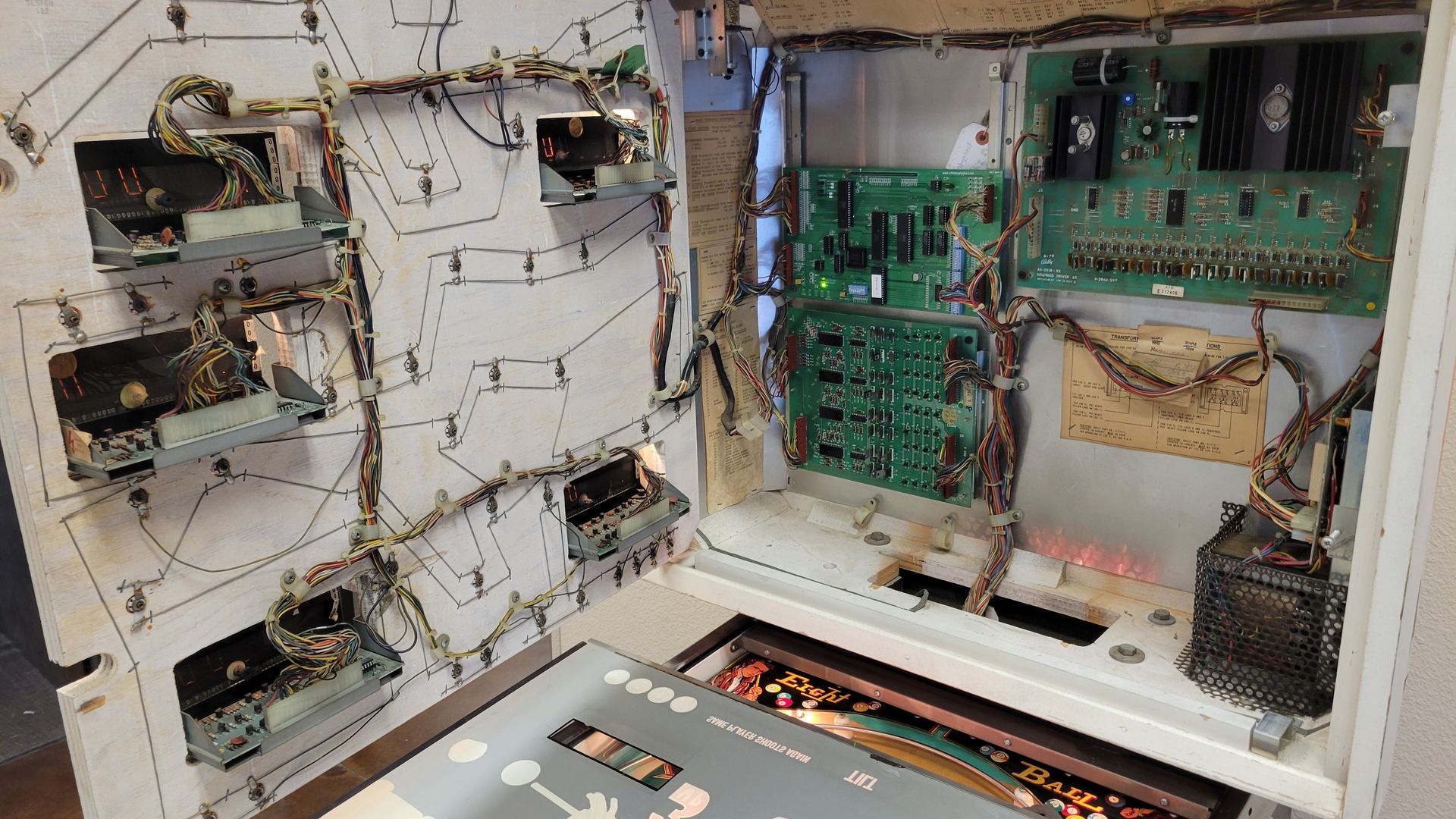A close up of the inside of a pinball machine.