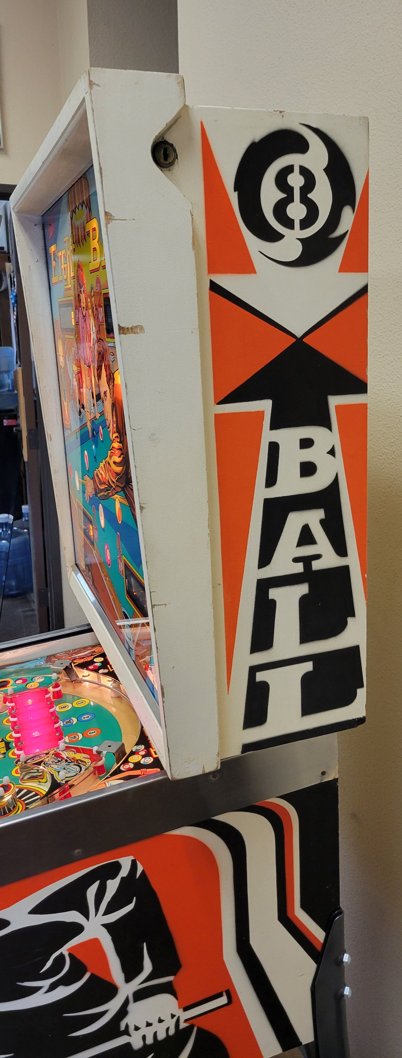 A close up of a pinball machine with the word ball on it.