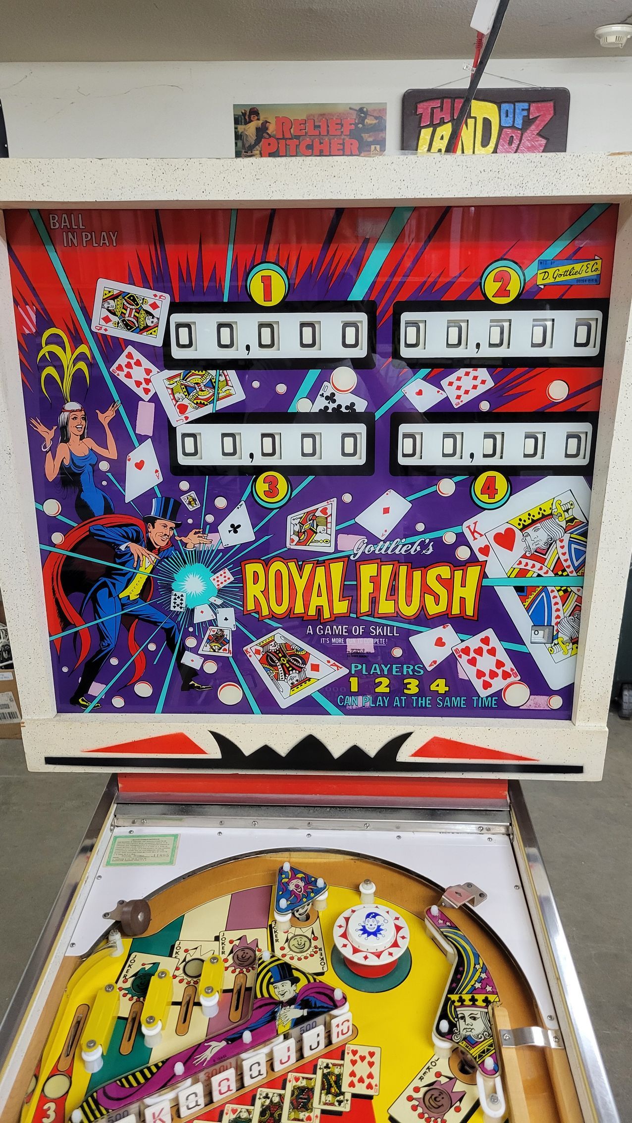 A pinball machine called royal plush is sitting on a table.