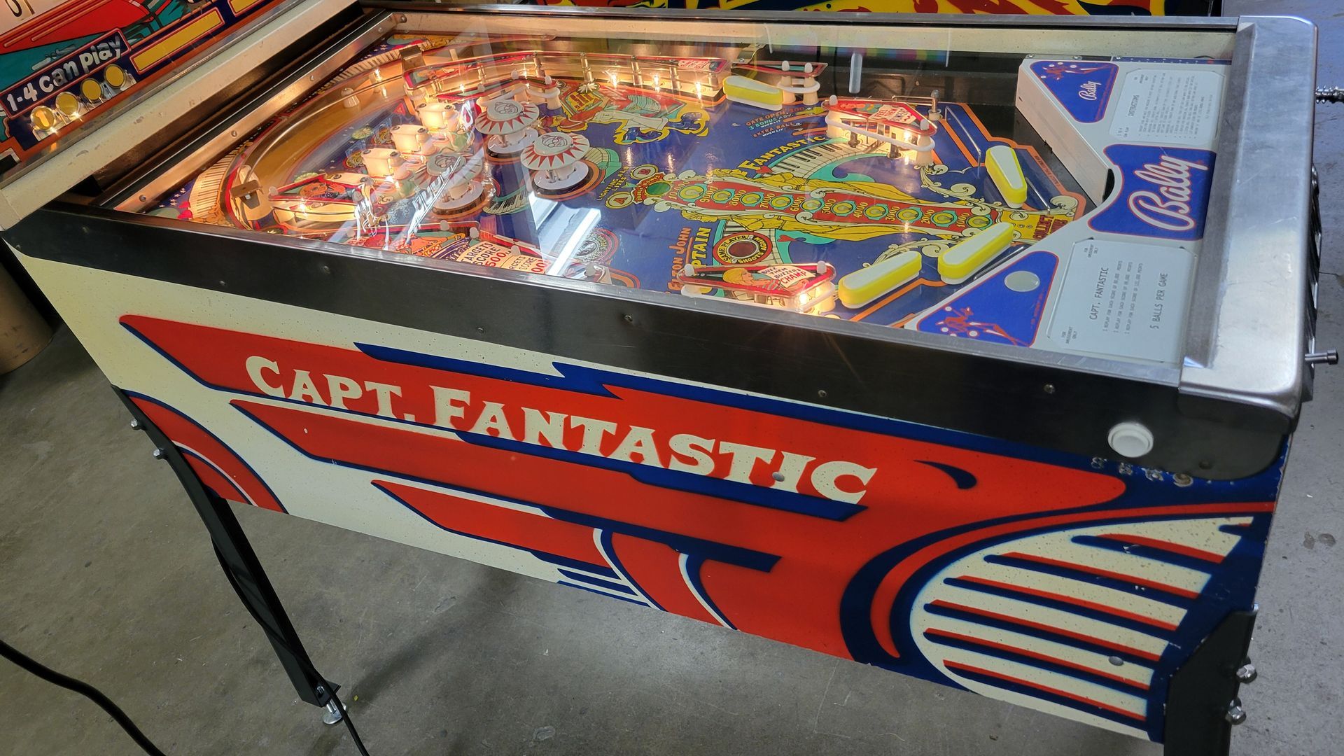 A pinball machine that says captain fantastic on it