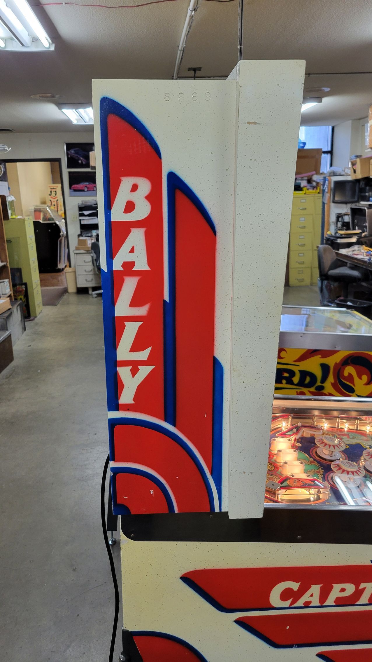 A red and white sign that says bally on it