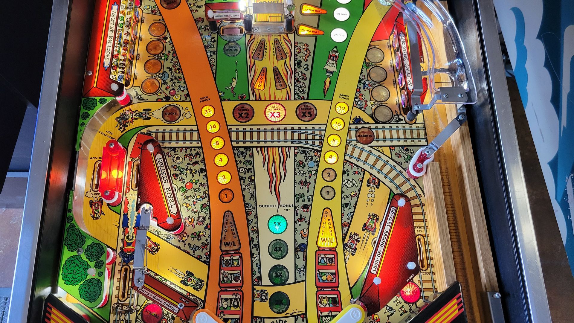 A close up of a pinball machine with a lot of balls on it