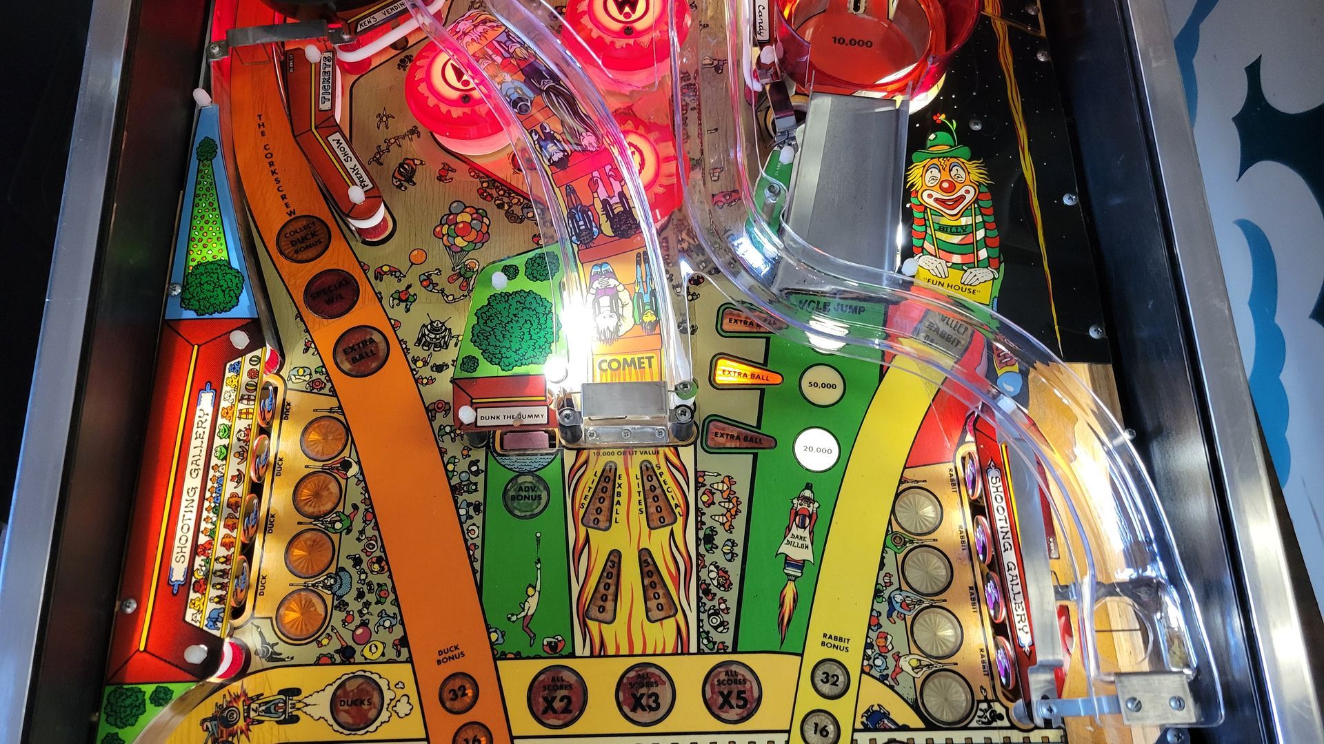 A pinball machine with a lot of coins on it