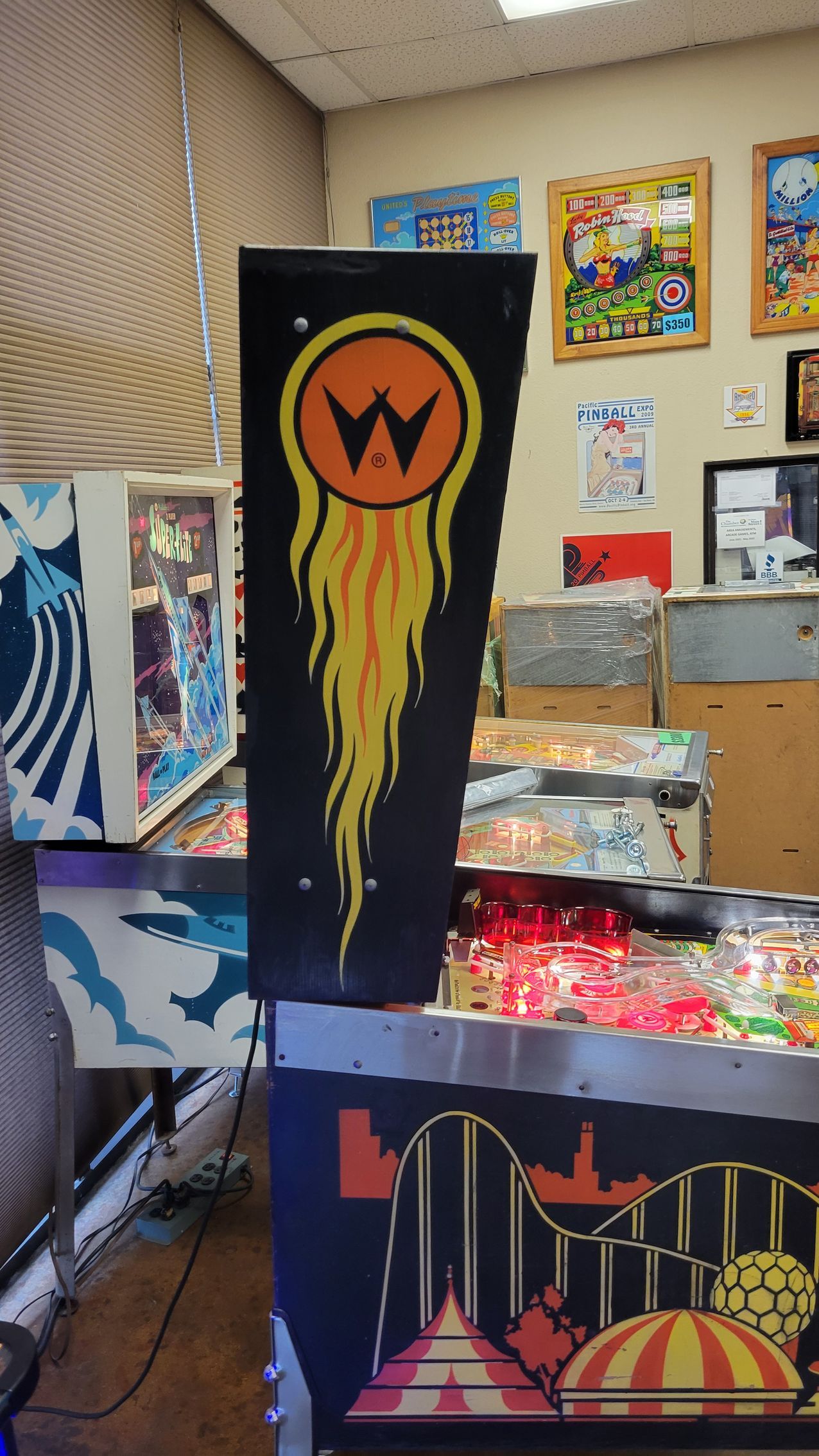 A pinball machine with a flame coming out of it