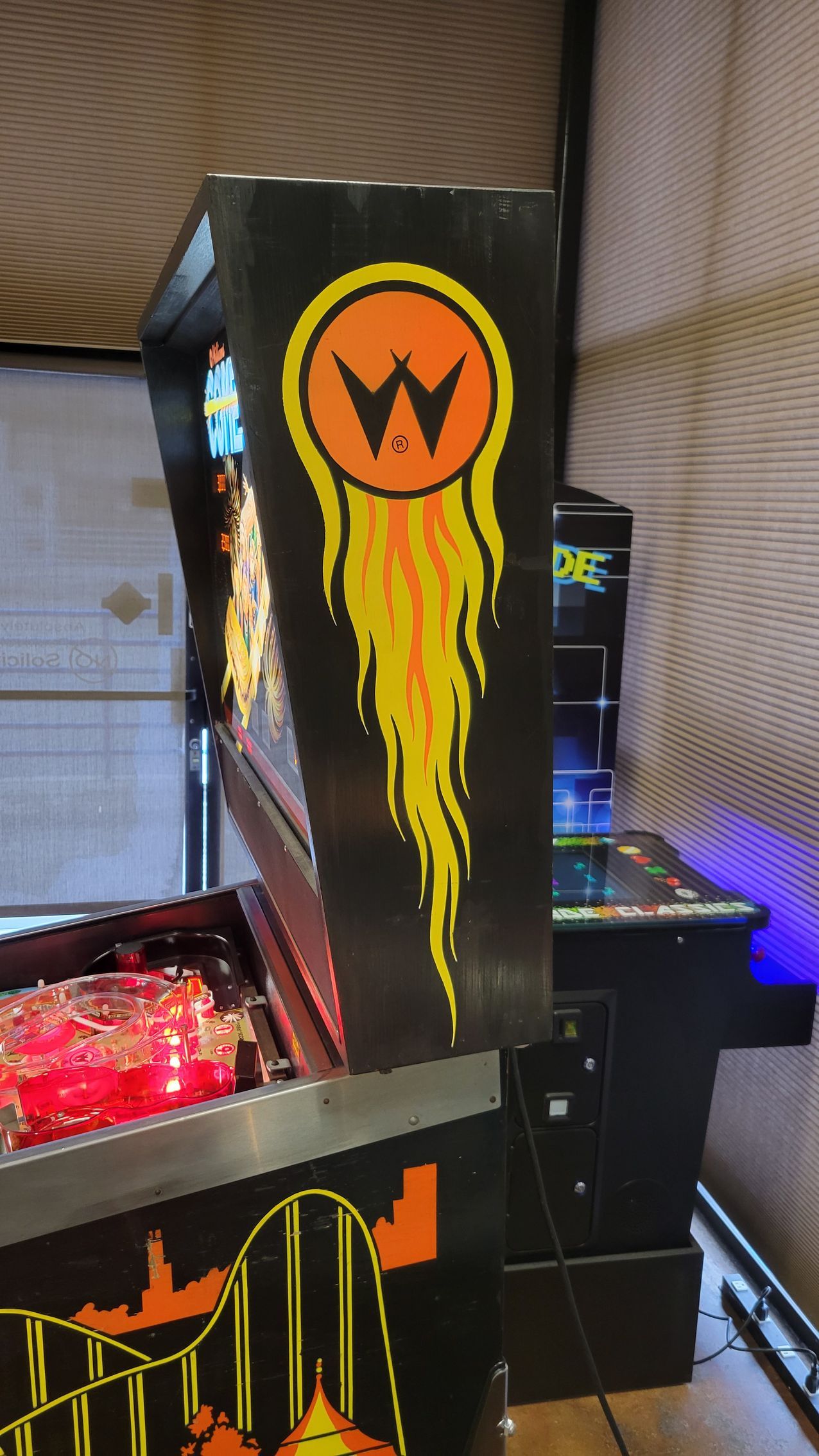 A pinball machine with a flame coming out of it