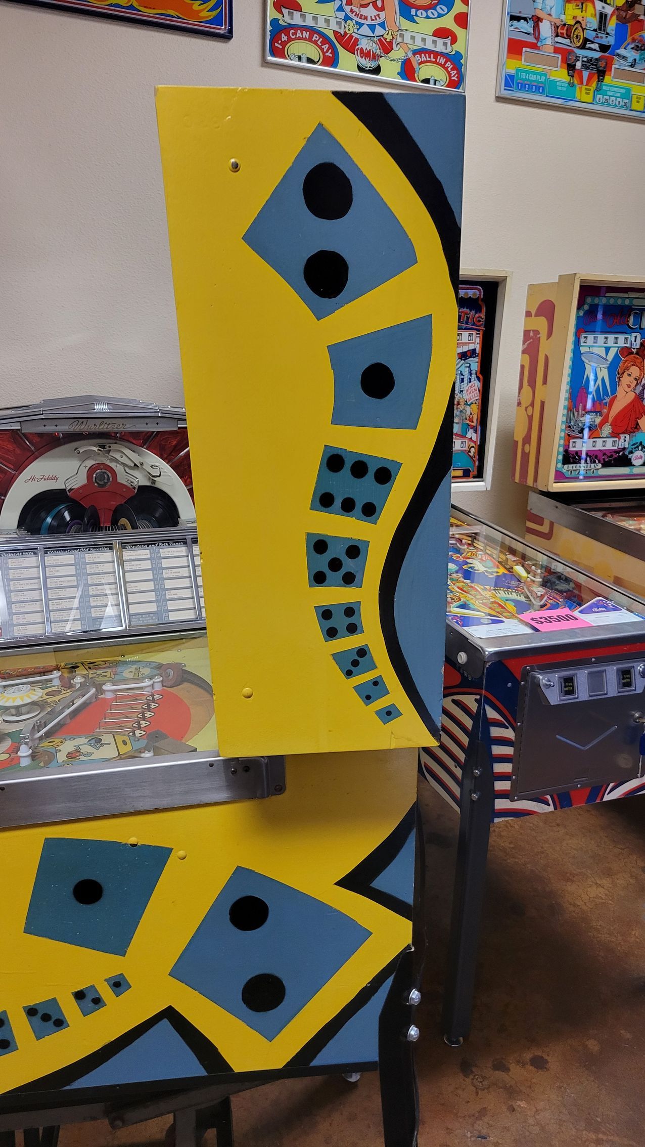 A pinball machine with a yellow and blue design
