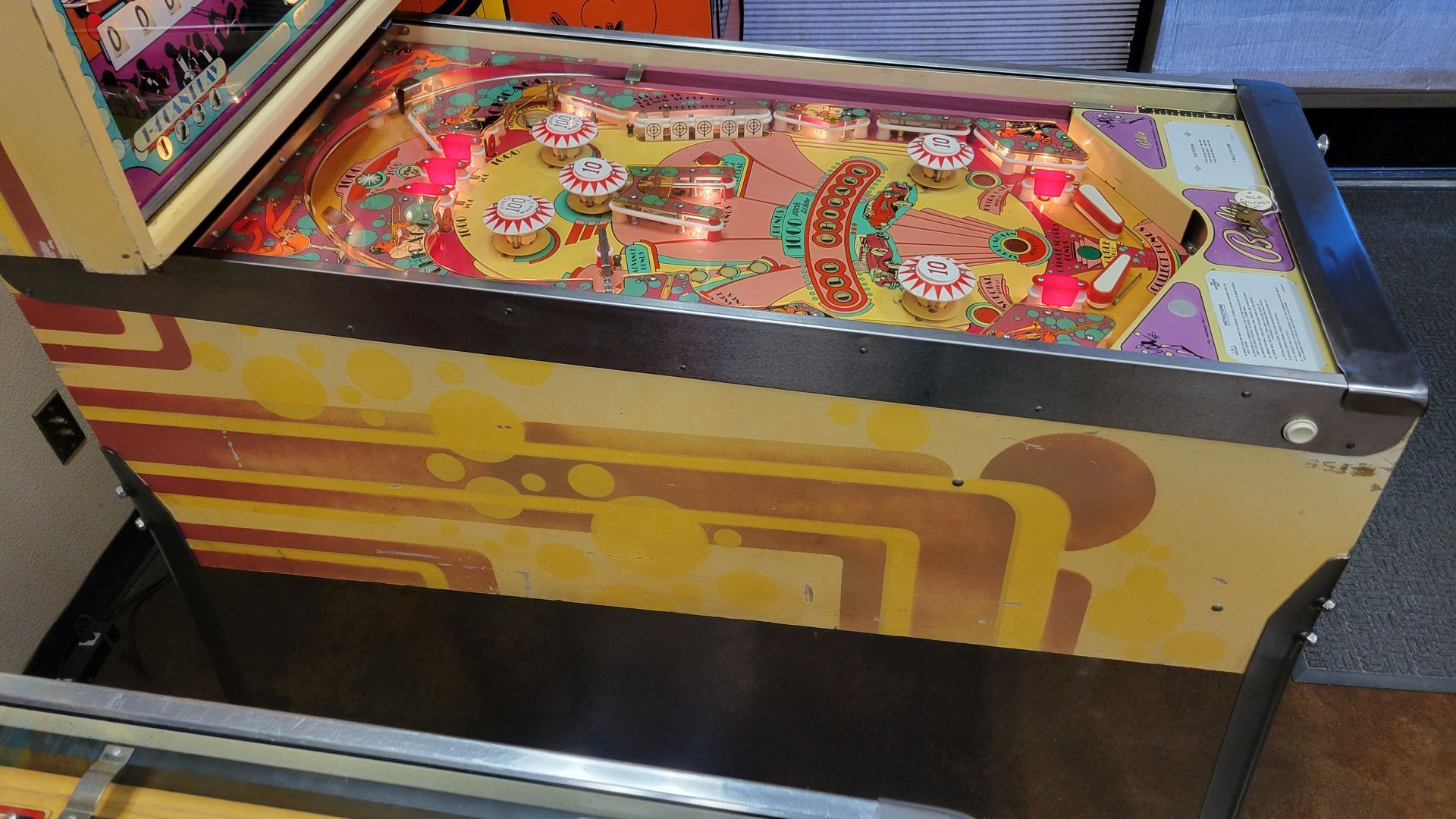 A pinball machine with a yellow and purple design on it