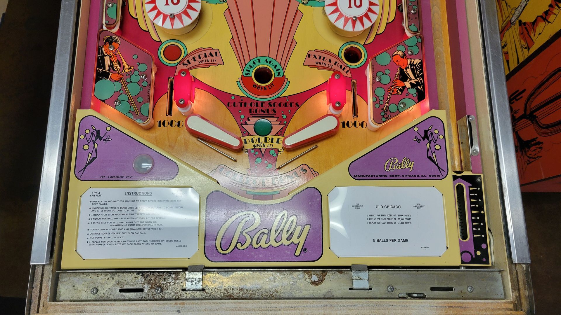 A bally pinball machine is sitting on a table