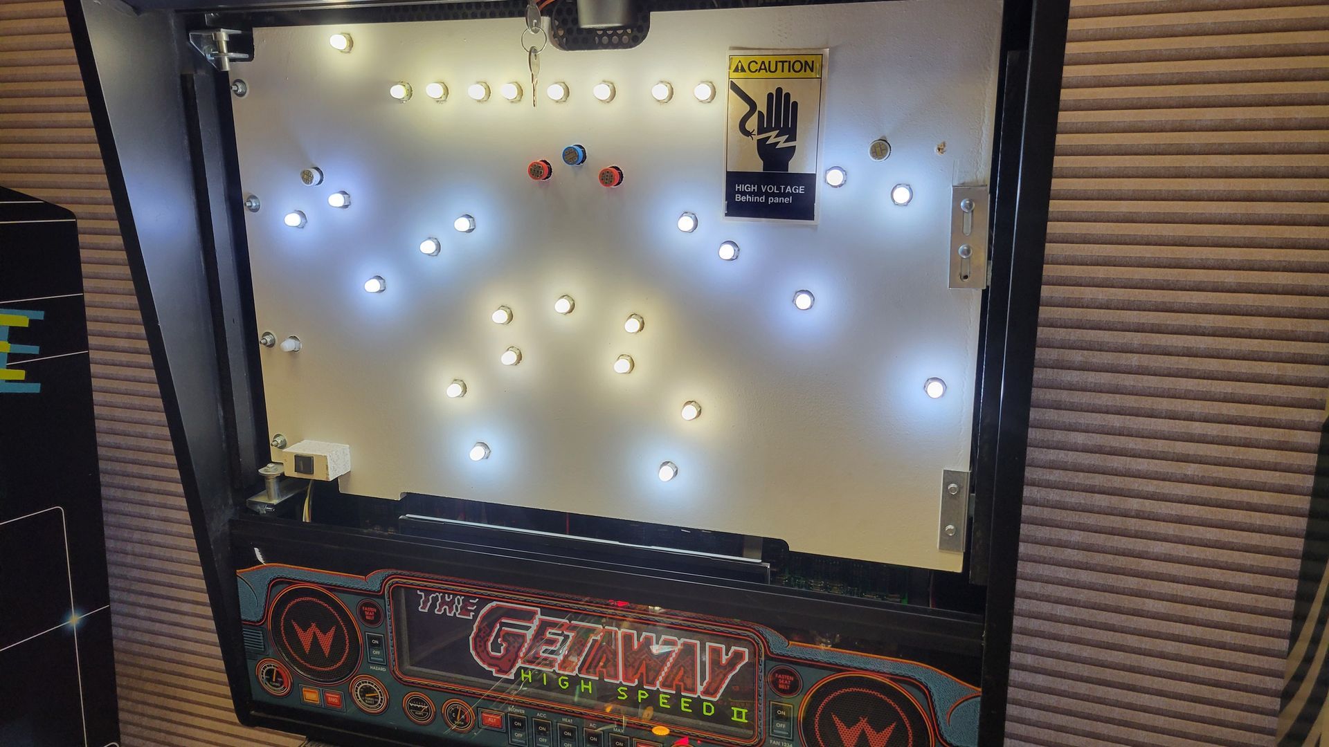 A pinball machine with a lot of lights on it.