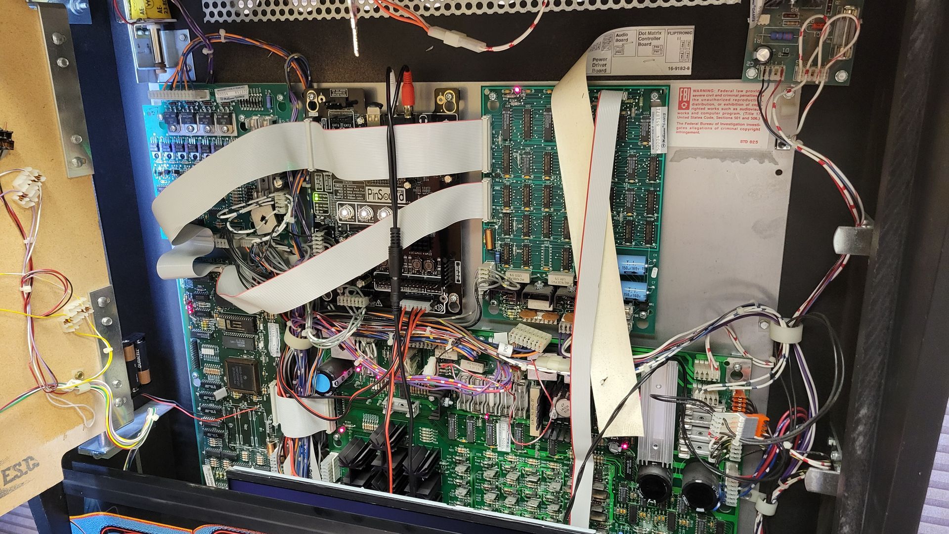 The inside of a machine with a lot of wires coming out of it