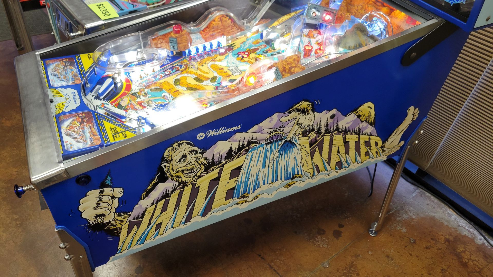A pinball machine with the word water on it
