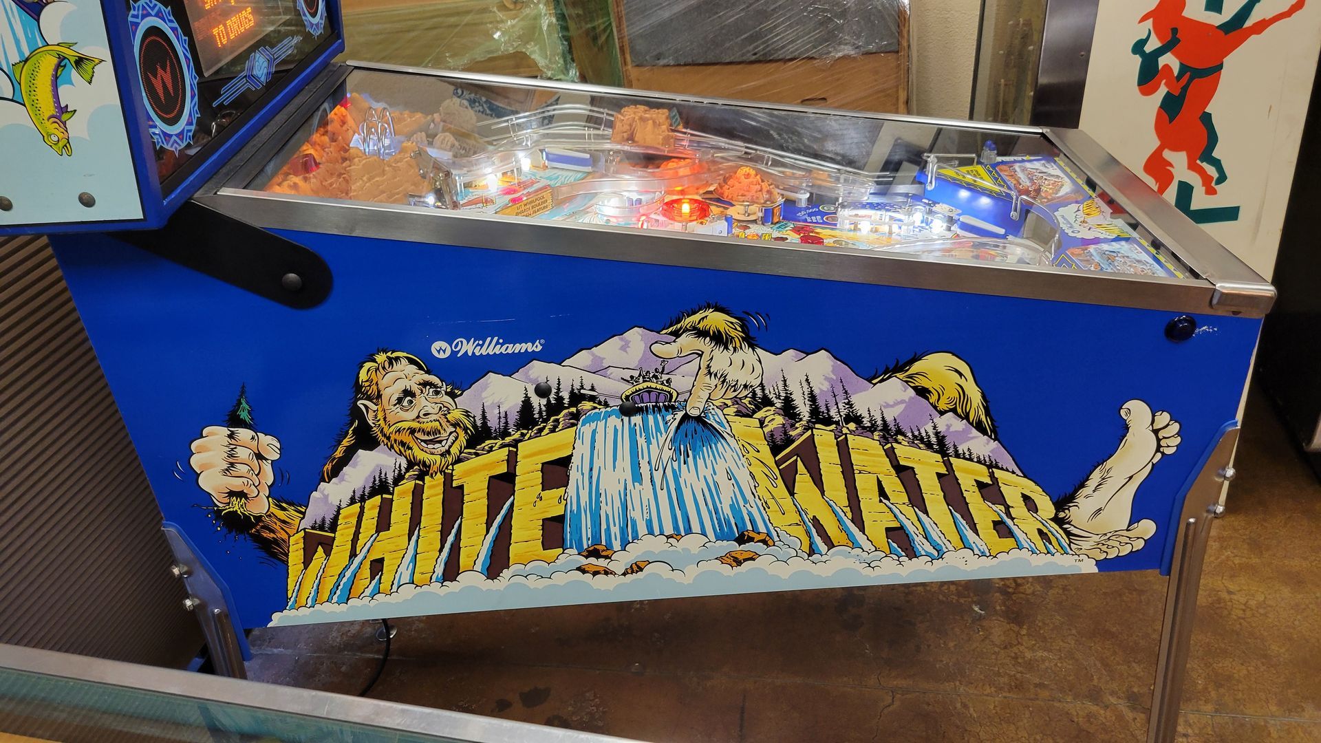 A pinball machine with the word whitewater on it