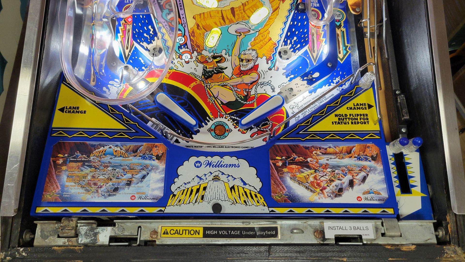 A pinball machine with a blue and yellow background