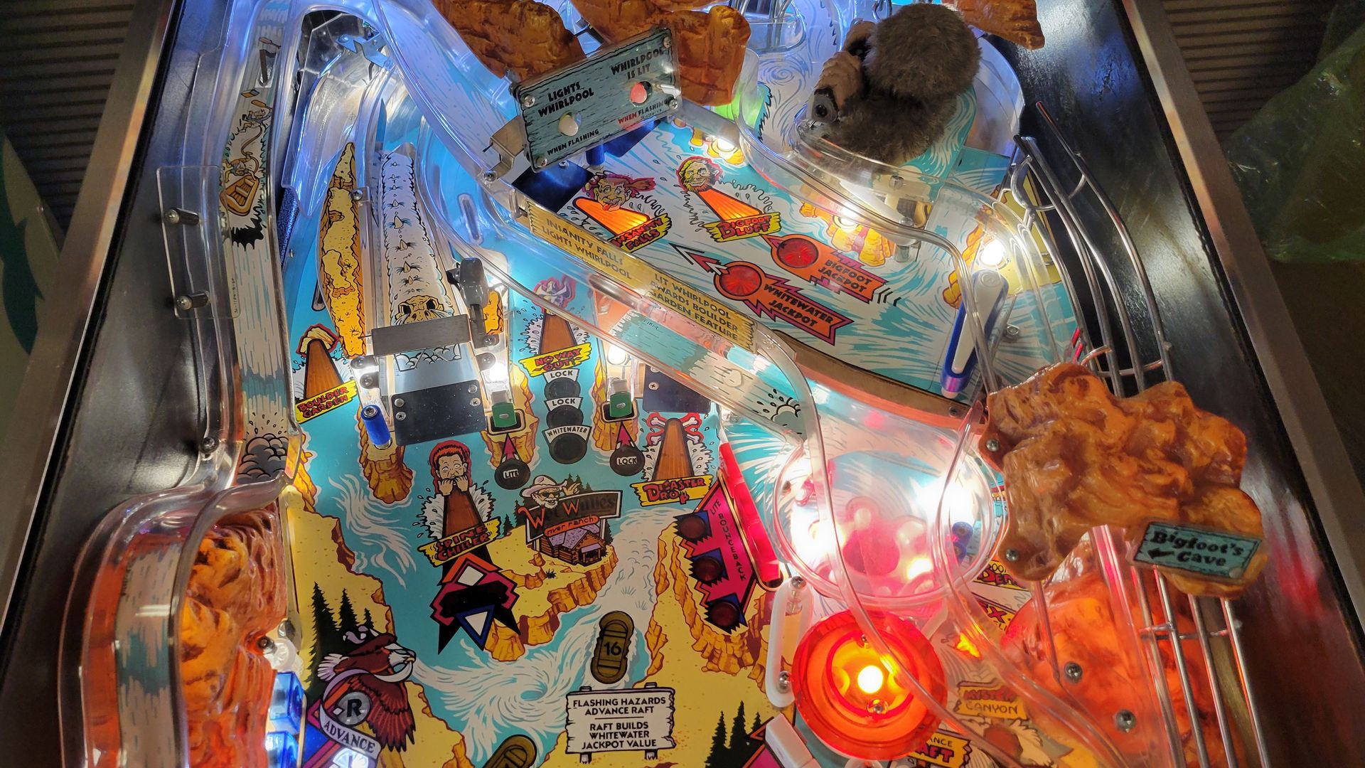 A close up of a pinball machine with lights on it.