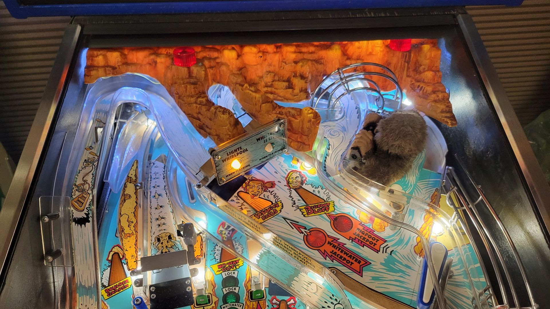 A close up of a pinball machine with lights on it.
