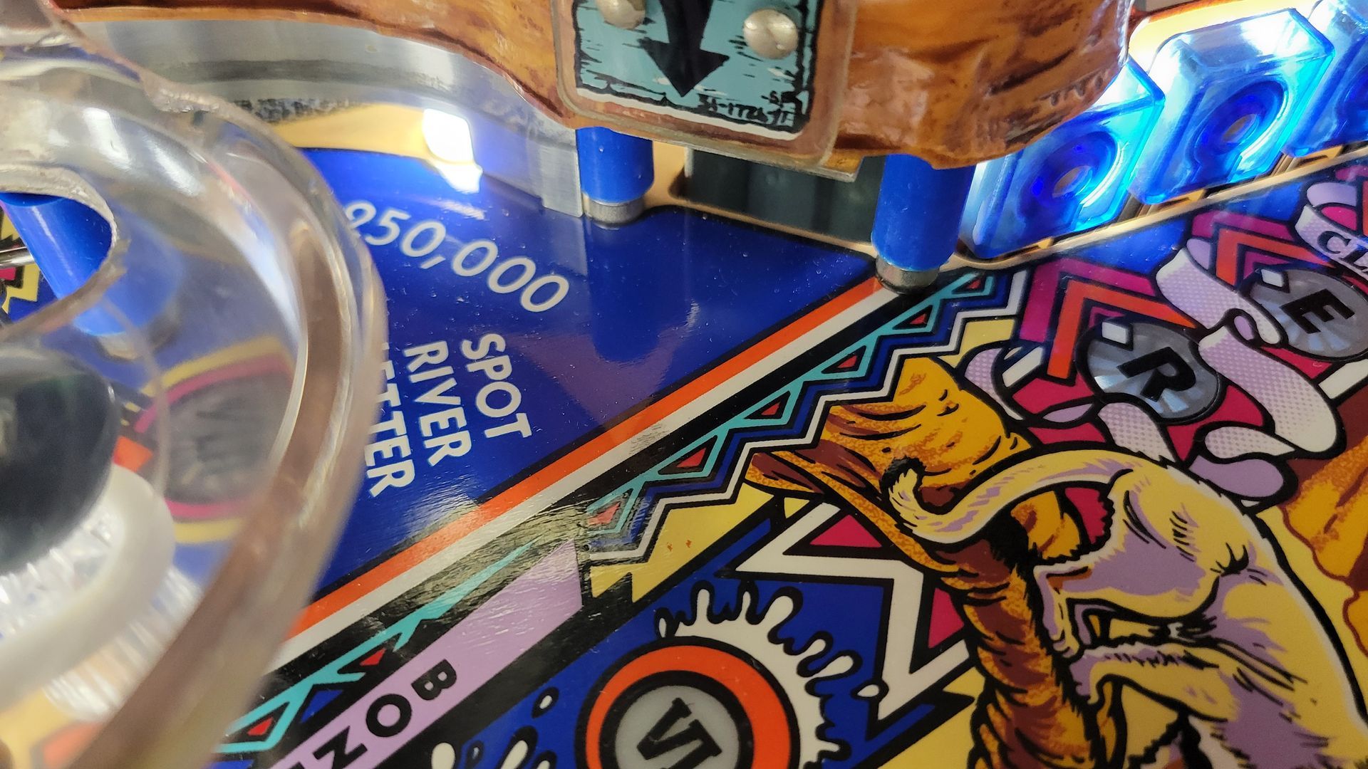 A close up of a pinball machine that says spot river water