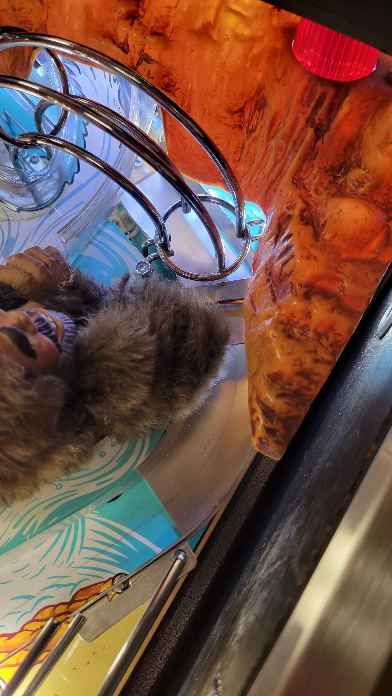 A close up of a person laying on a table next to a bag of food.