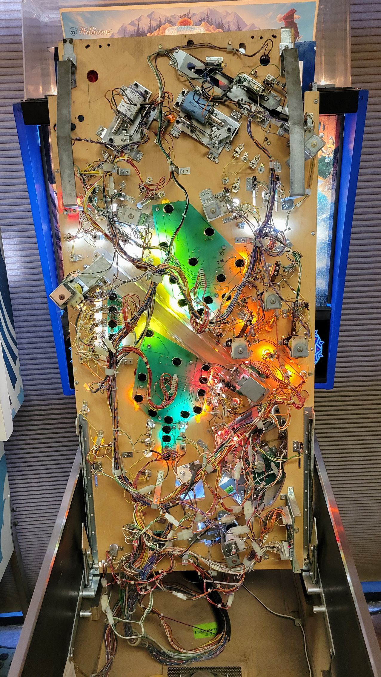 A close up of a pinball machine with lights on it.