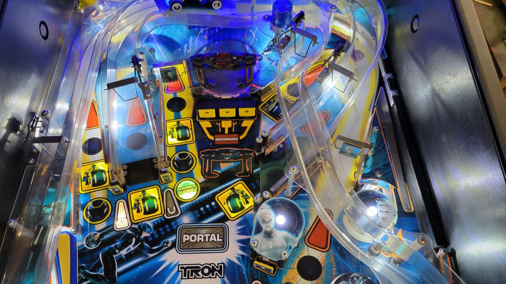 A close up of a pinball machine with a lot of lights on it.