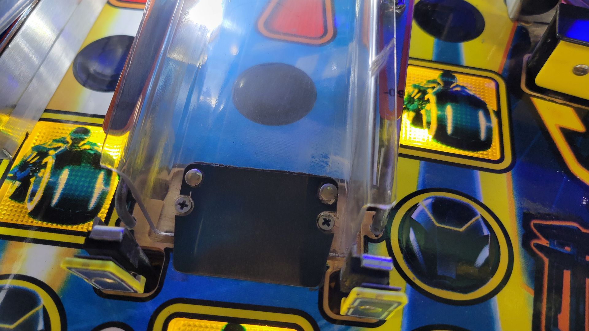 A close up of a pinball machine with a blue and yellow background.
