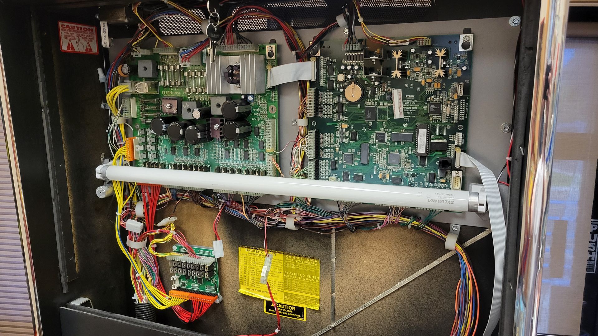 The inside of a machine with a lot of wires coming out of it.