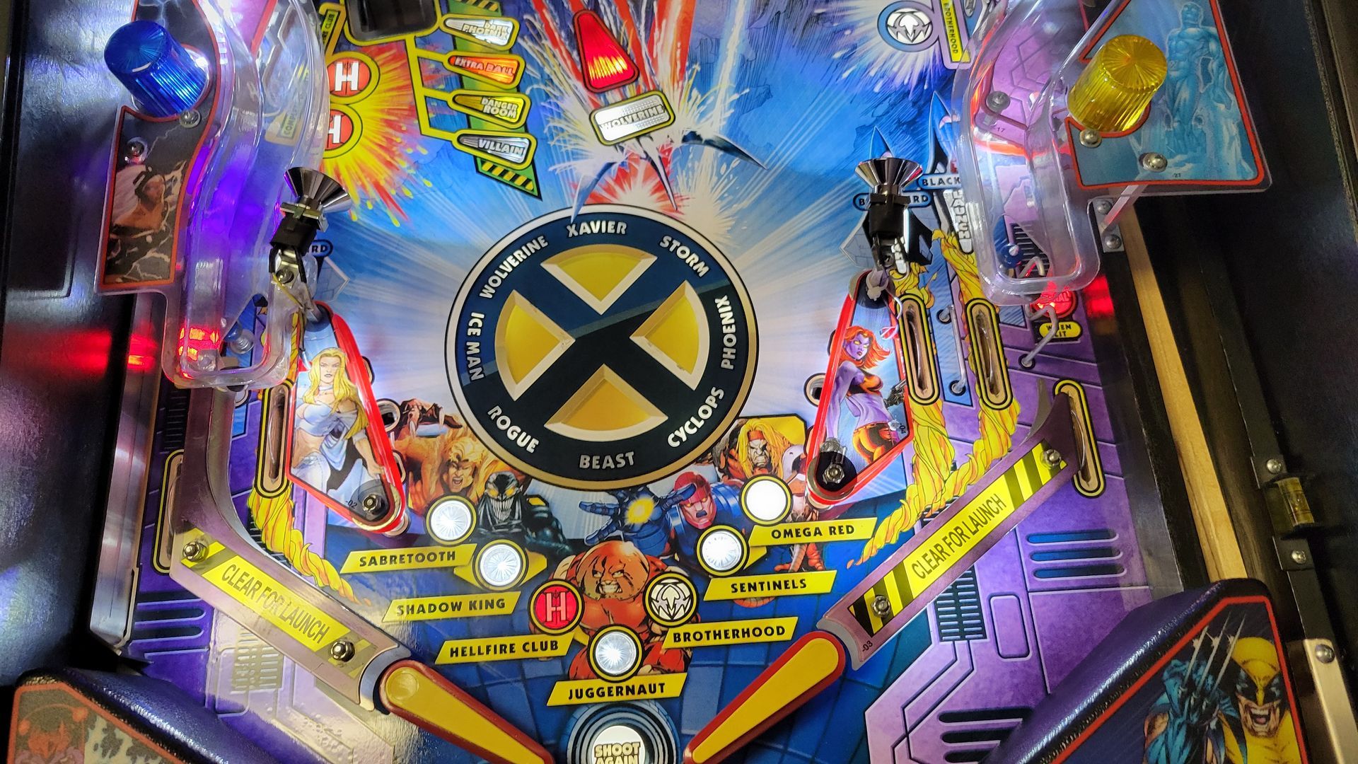 A pinball machine with a x-men logo on it.