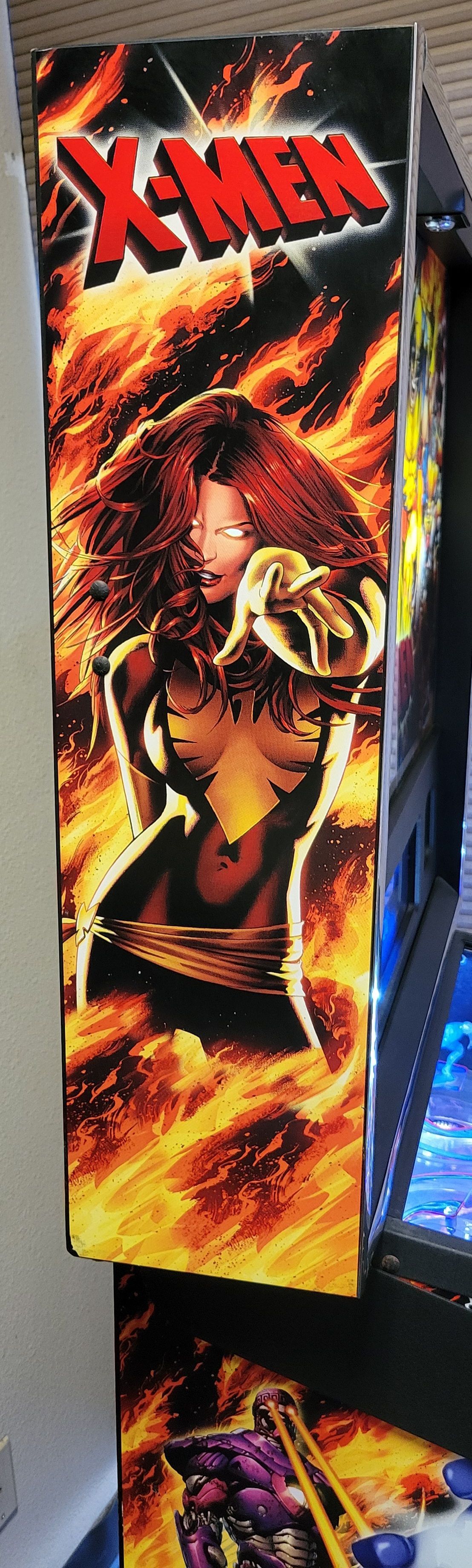A x-men arcade game with a picture of phoenix on the side.