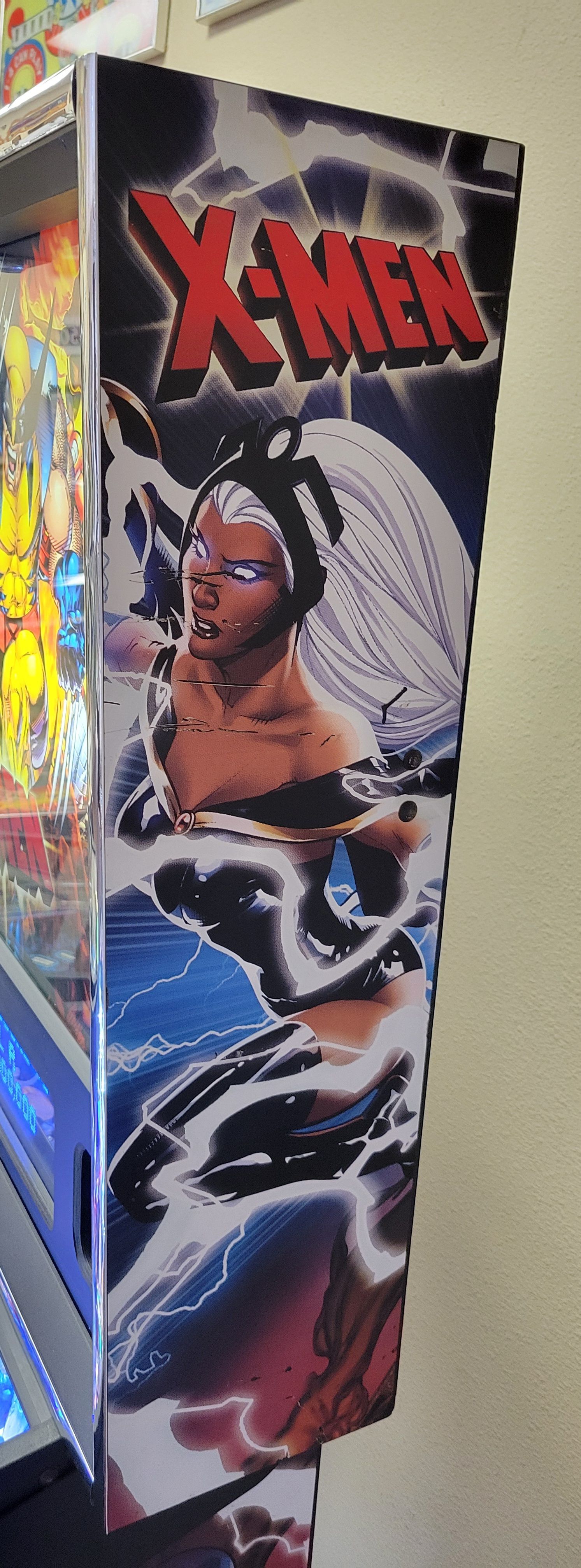A x-men pinball machine is sitting on a table.