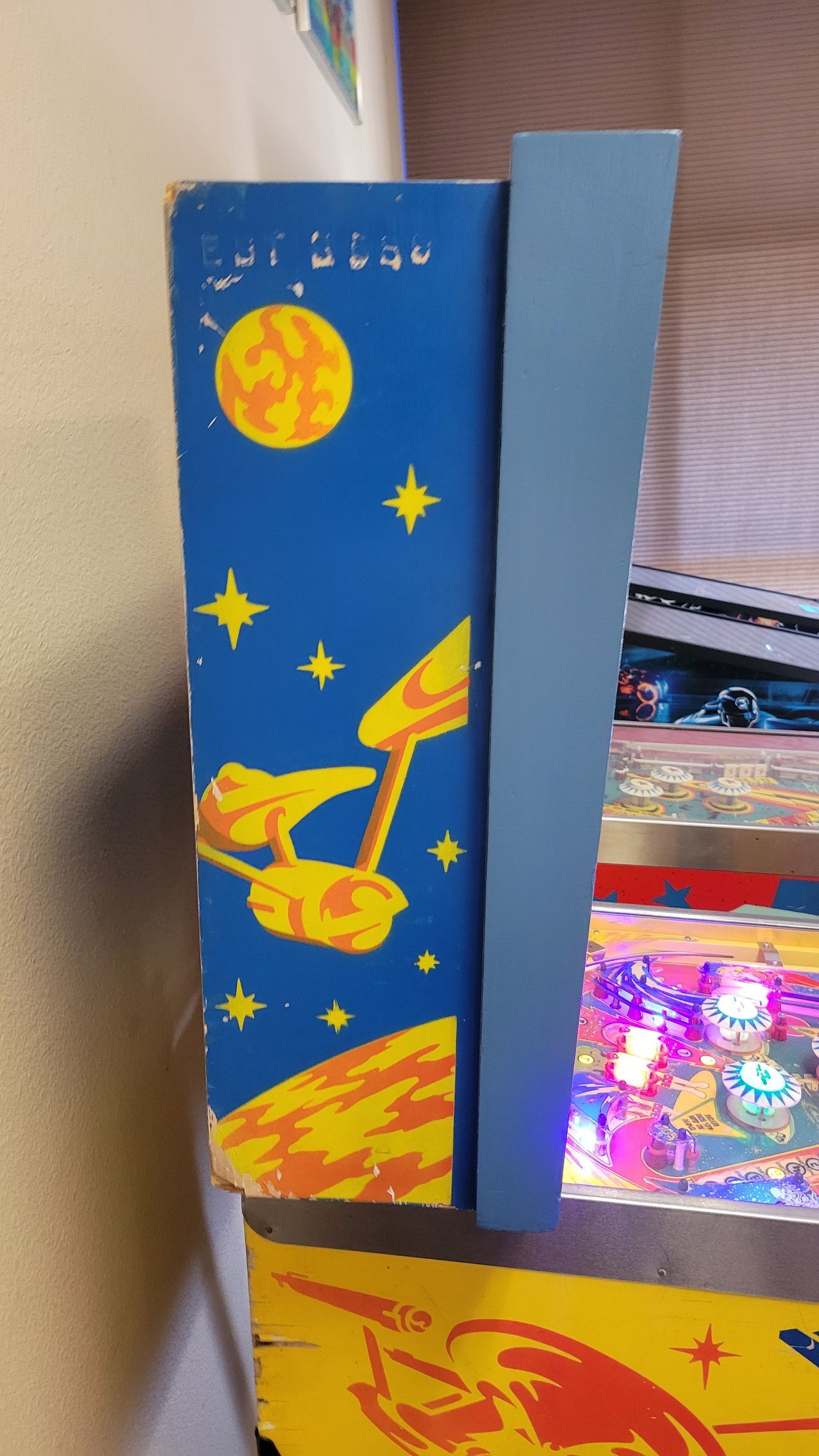 A blue and yellow item with a rocket on it