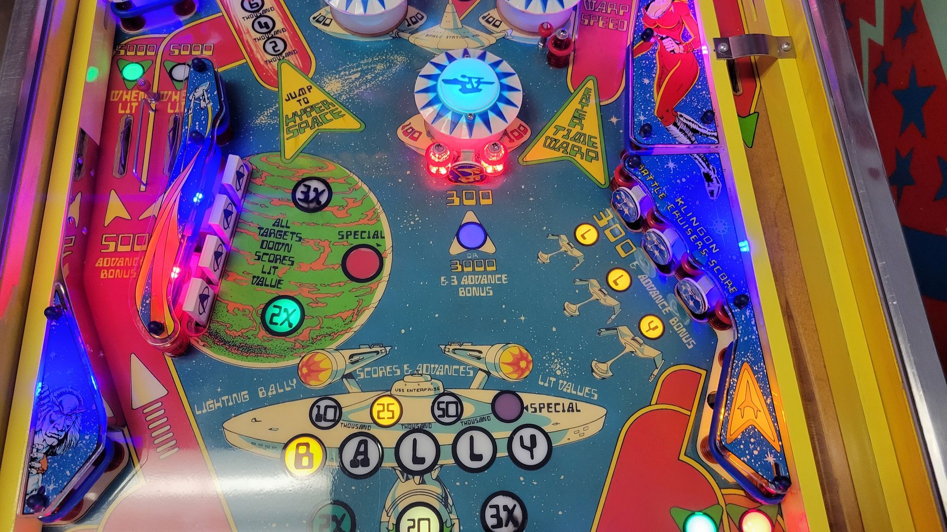 A pinball machine with a lot of lights on it.