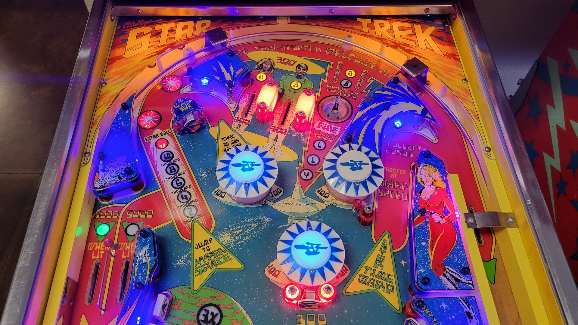 A close up of a pinball machine with lights on it.
