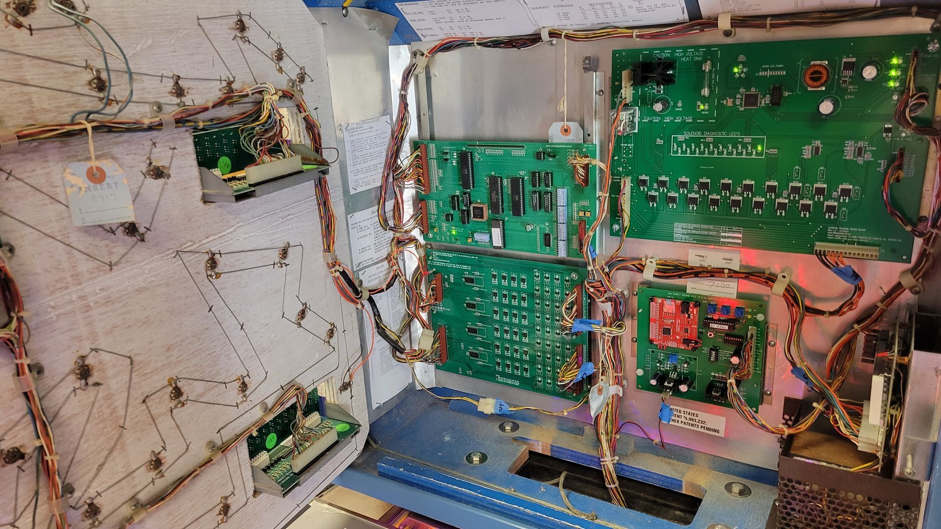 A close up of the inside of a pinball machine.