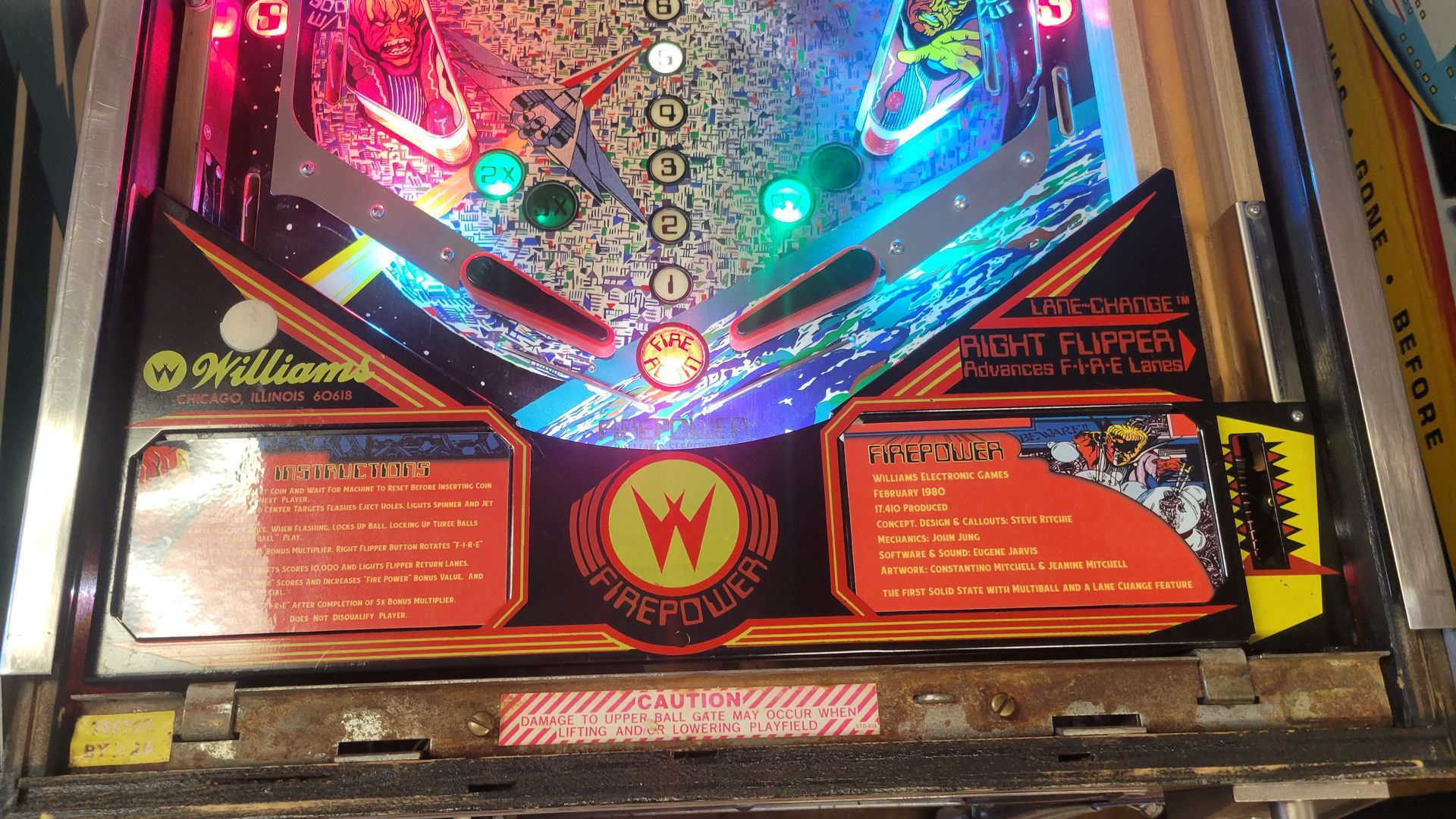 A pinball machine with a yellow w on it