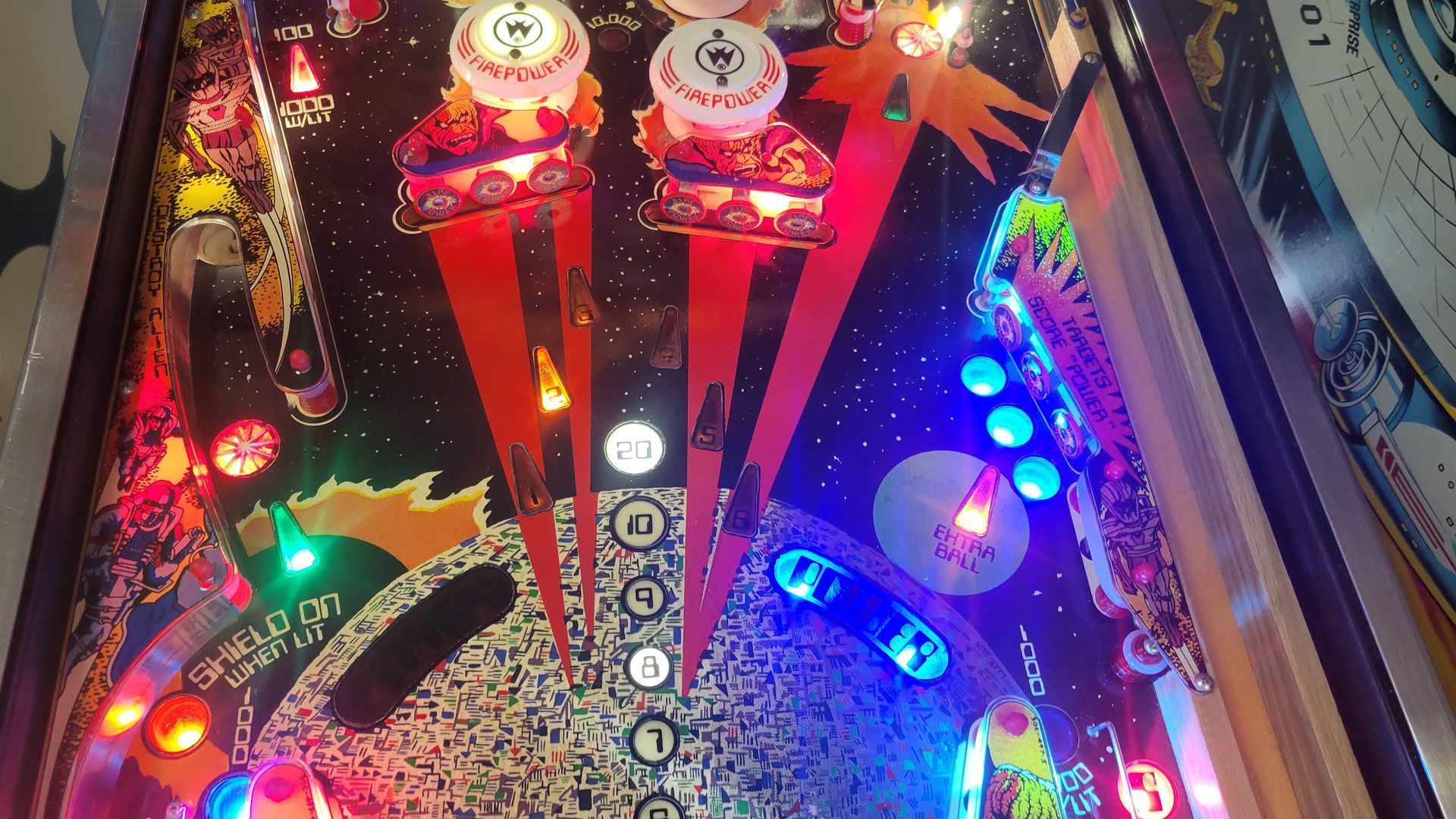 A pinball machine with a lot of lights on it