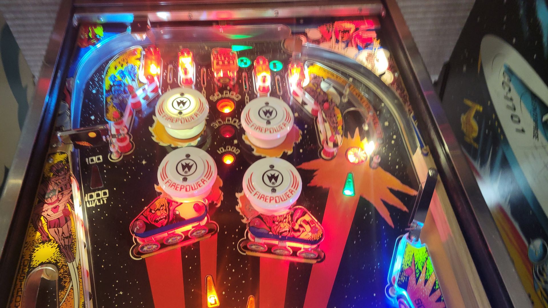 A pinball machine with a picture of a plane on it