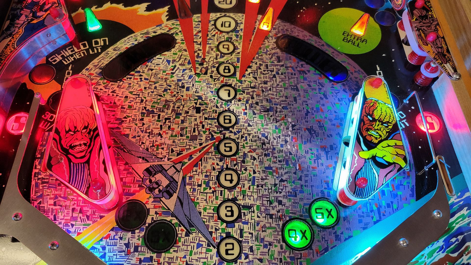 A close up of a pinball machine with a few buttons on it