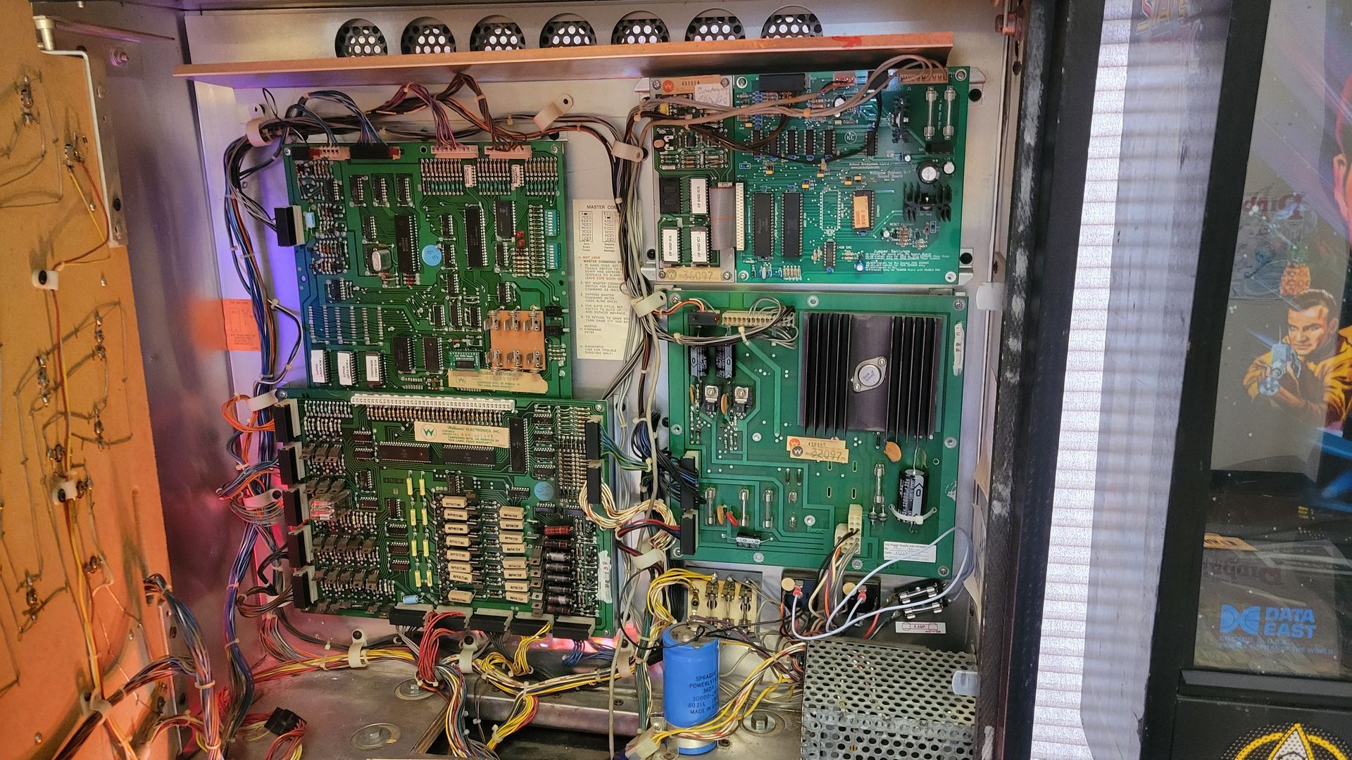 The inside of a machine with a lot of wires coming out of it.