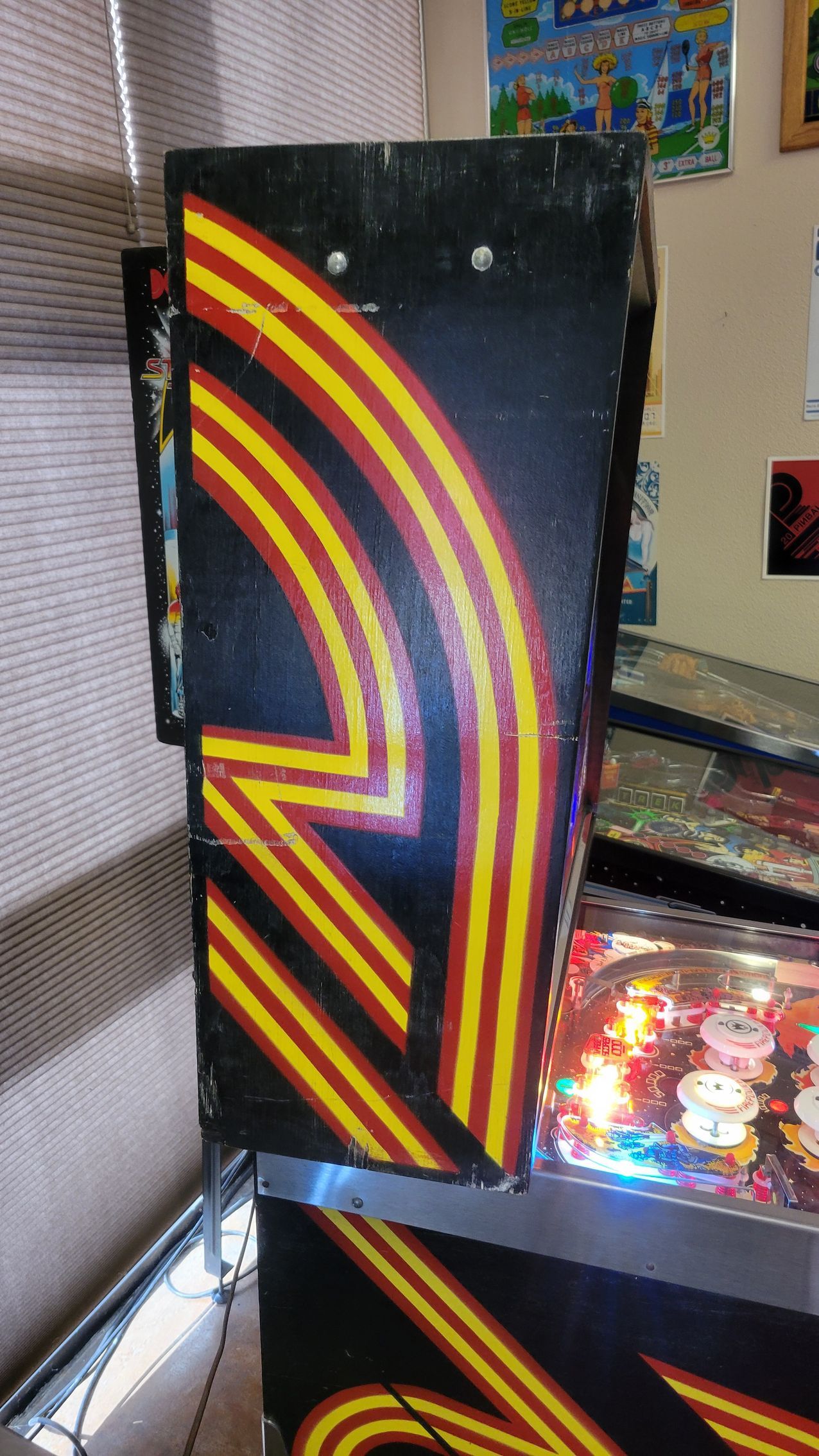 A pinball machine with red and yellow stripes on it