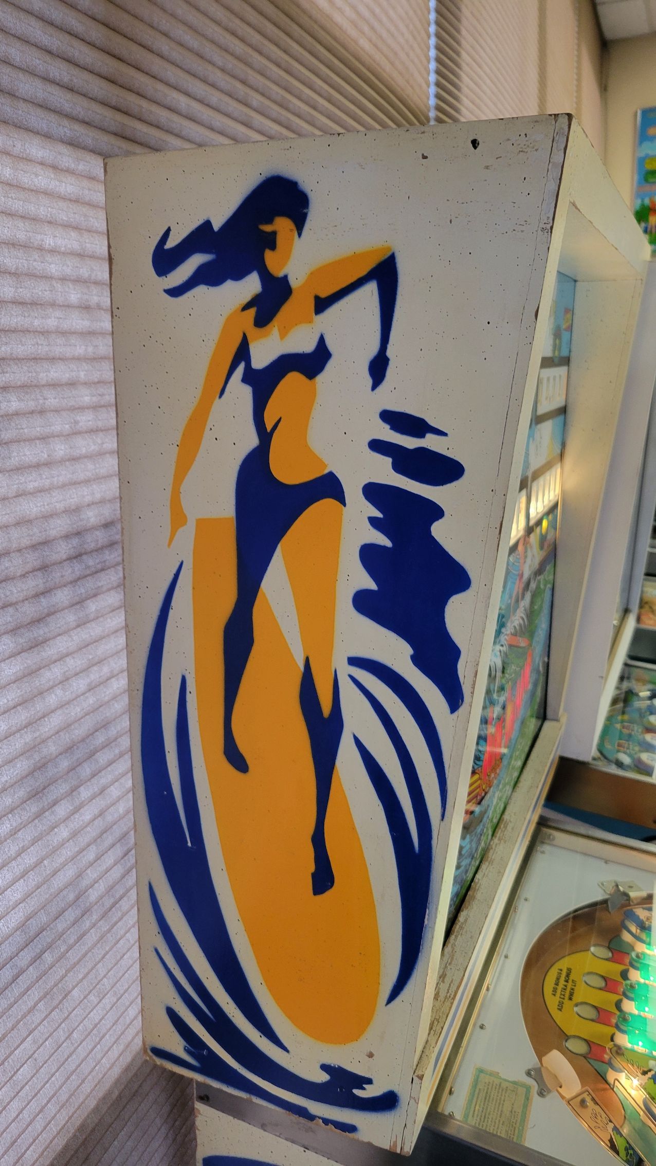 A woman in a bikini is riding a wave on a surfboard