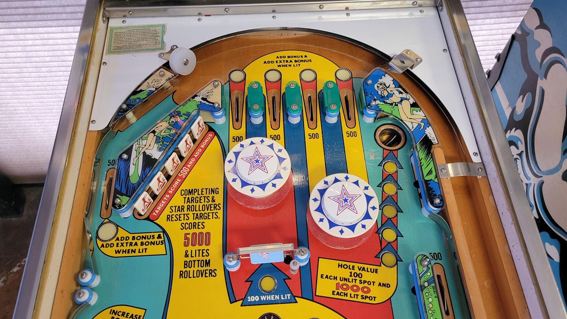 A pinball machine that says ' oasis ' on it