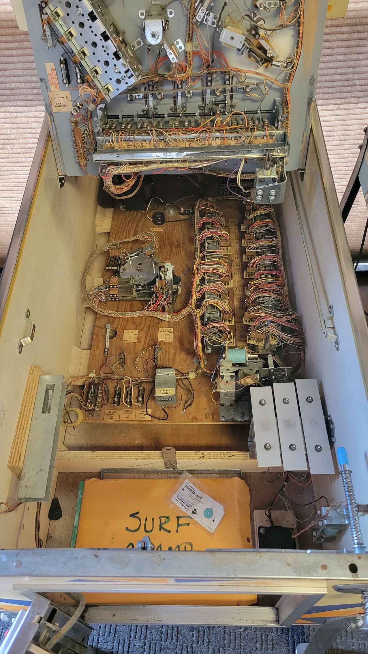 The inside of a pinball machine is shown.