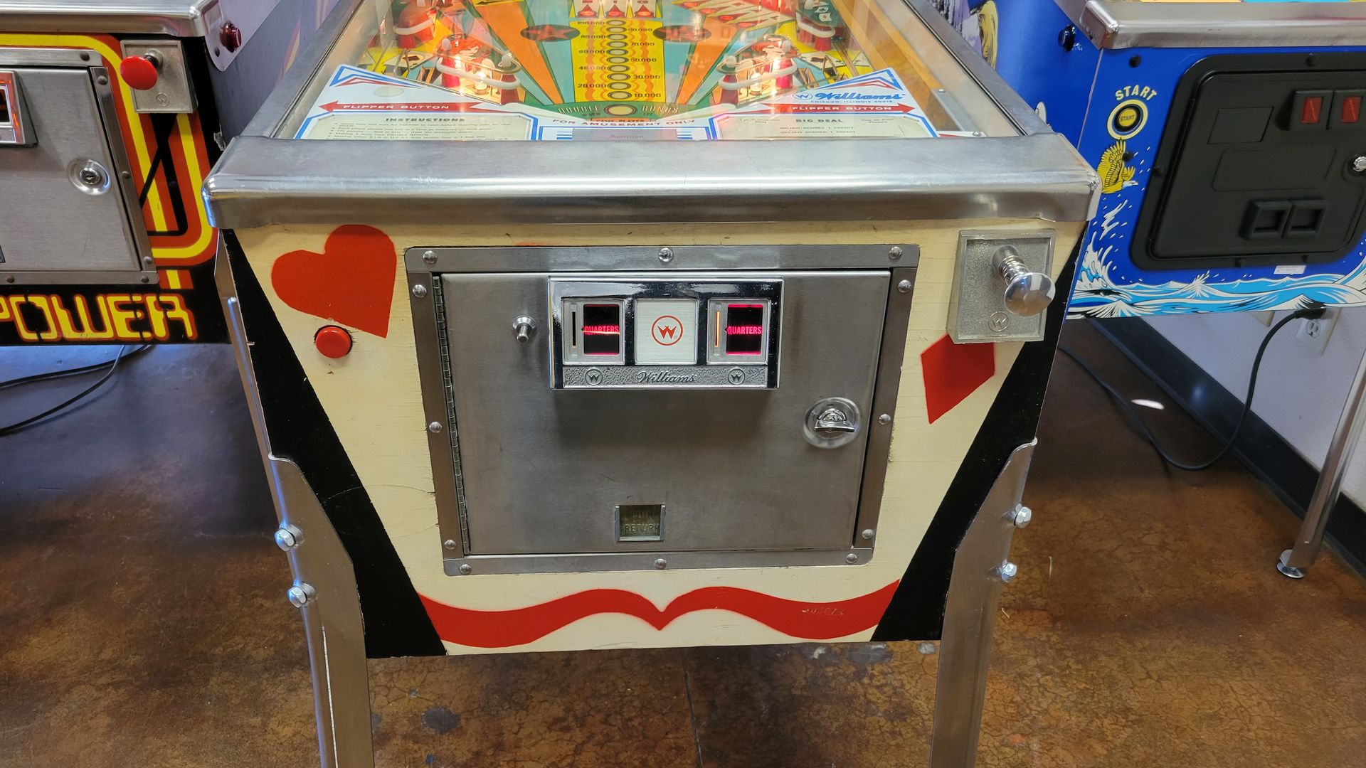 A pinball machine with a playing card design on it