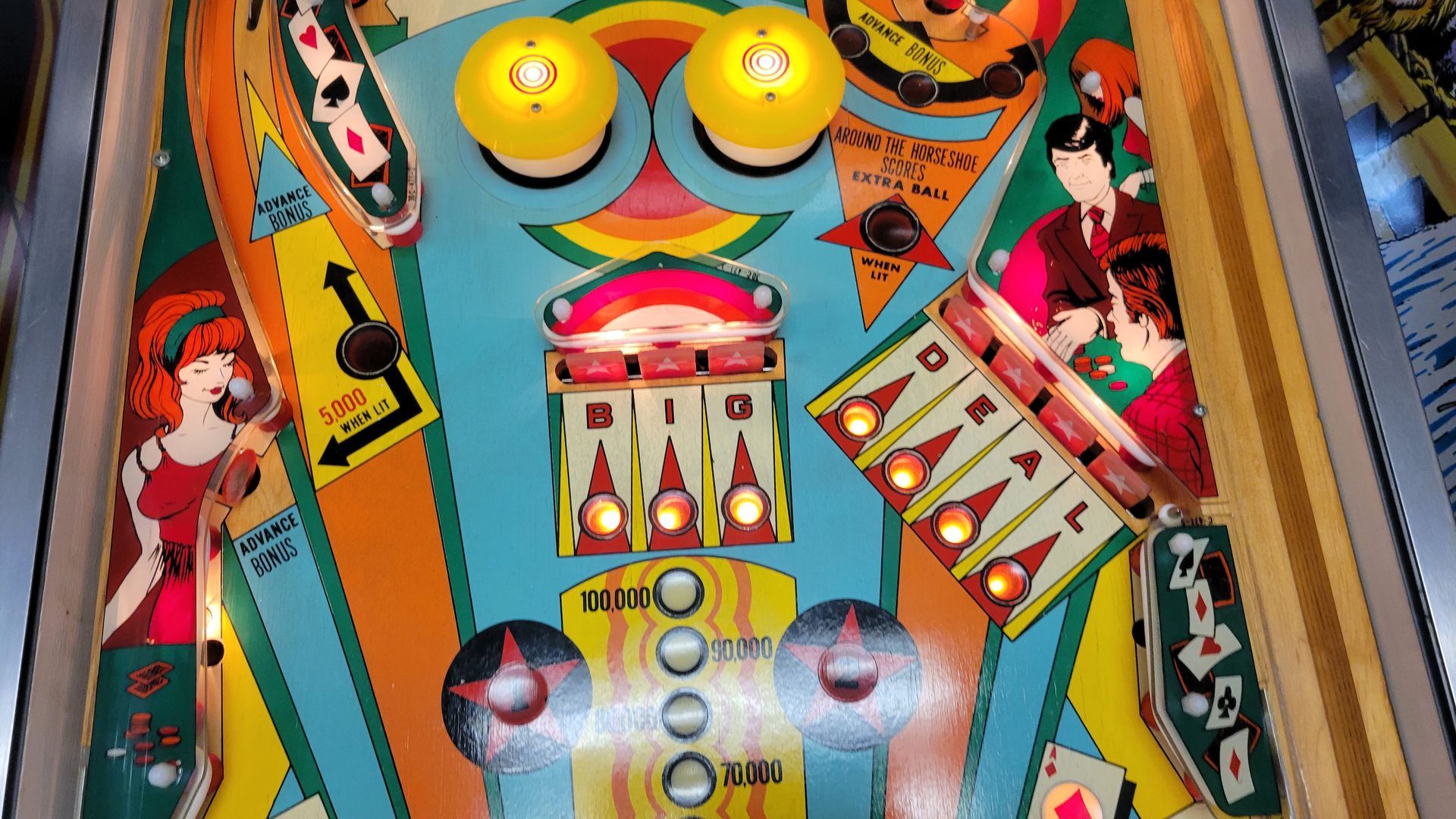 A close up of a pinball machine with a cartoon character on it.