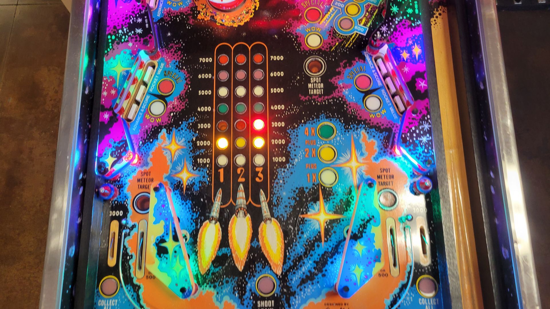 A pinball machine with a red light on it