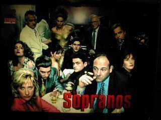 A group of people sitting around a table with sopranos written on the bottom