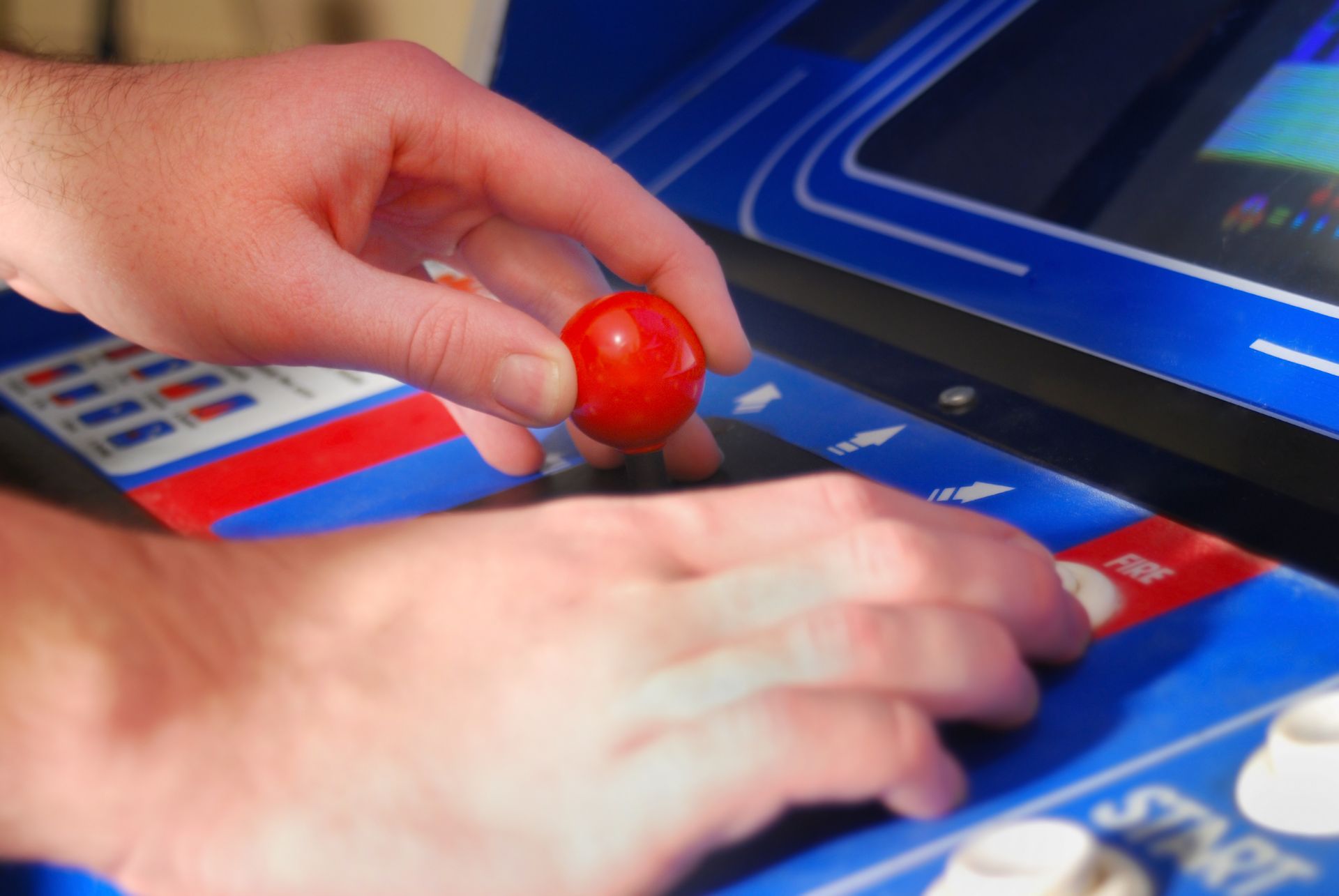 A close-up of a hand holding a red ball for a Residential Arcade Repairs